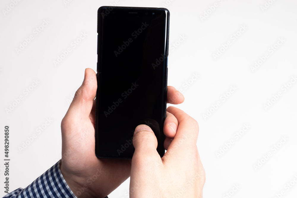 Poster hands holding a smartphone. an empty smartphone screen with space for text. the man uses a mobile ph