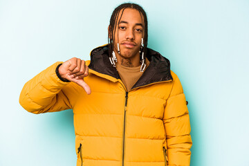 Young African American man isolated on blue background showing a dislike gesture, thumbs down....