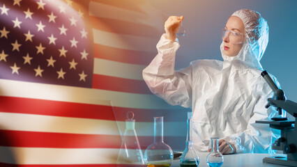 Scientific research in the USA. A female chemist in a protective suit. A scientist on the...
