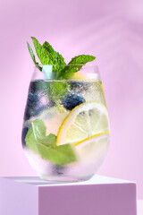 Blackberry and lemon refreshing summer infused water on podium