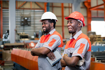 Professional Mechanical Engineer team Working on Personal Computer at Metal lathe industrial manufacturing factory. Engineer Operating lathe Machinery. Product quality Inspection 