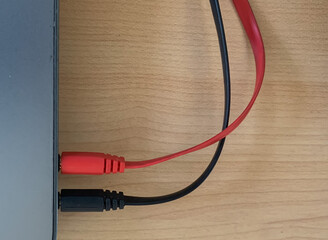 This headset adapter connects a laptop or computer with an audio device that only has one plug