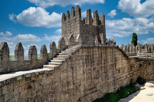 Tourists walking along the walls of The Castle of Guimarães, Portugal.
