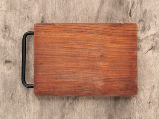 Empty wooden board over wooden table with copy space