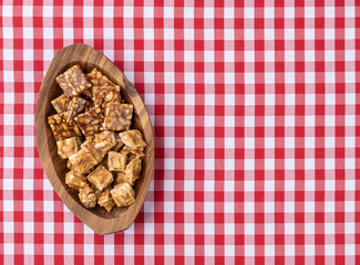 Pe de moleque, typical brazilian peanut candy over plaid fabric. June festival food