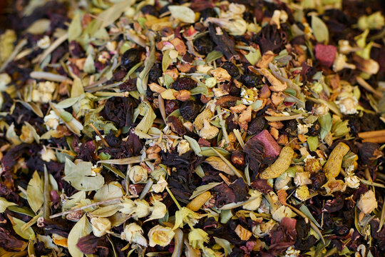 Mixed tea with dried fruits and dried flowers and herbs. Tea texture background