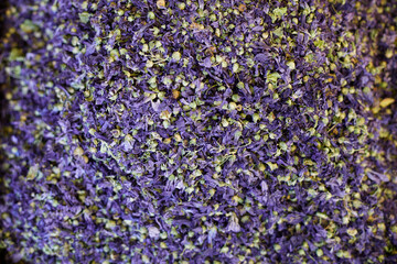Dried Malva sylvestris petals, herbal tea texture background. Dry flower buds for sale at market