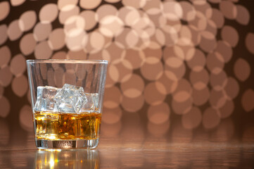 whiskey on the rocks on bokeh back ground with copy space