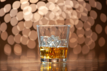 whiskey on the rocks on bokeh back ground