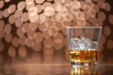 whiskey on the rocks on bokeh back ground with copy space