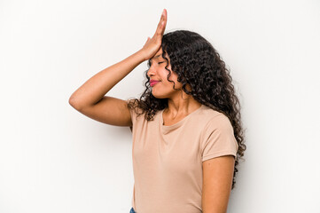 Young hispanic woman isolated on white background forgetting something, slapping forehead with palm and closing eyes.