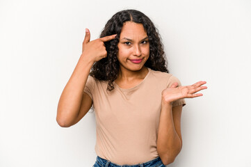 Young hispanic woman isolated on white background showing a disappointment gesture with forefinger.