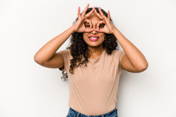 Fototapeta premium Young hispanic woman isolated on white background excited keeping ok gesture on eye.