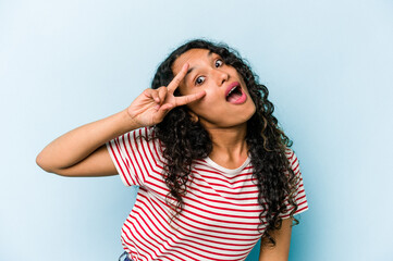 Fototapeta premium Young hispanic woman isolated on blue background dancing and having fun.
