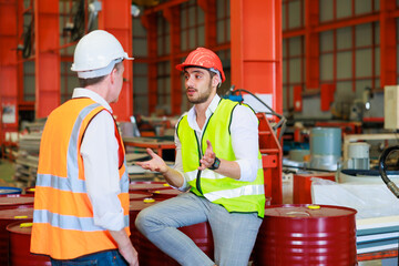 Professional engineer team male worker wearing safety hard hat helmet inspecting metal raw...