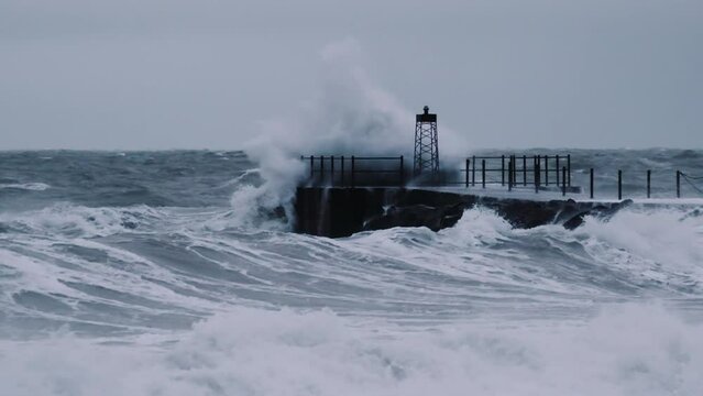 Hurricane Causing Waves To Crash Over Rocks And Pier