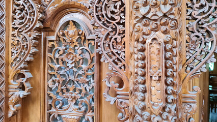 Pattern of flower carved on wood background.
