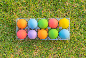 Fototapeta na wymiar Colorful easter eggs on natural green grass background. Food decoration on holiday.