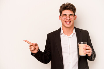 Young caucasian business man holding takeaway coffee isolated on white background smiling and pointing aside, showing something at blank space.