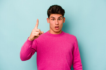 Fototapeta premium Young caucasian man isolated on blue background having some great idea, concept of creativity.