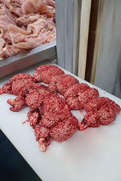 butcher board with beef brains on it. Beef brains on a butcher's table