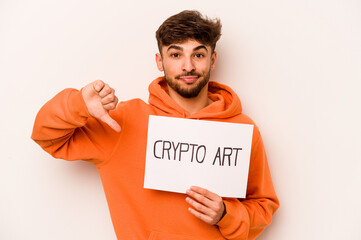 Young hispanic man holding a crypto art placard isolated on white background showing a dislike gesture, thumbs down. Disagreement concept.