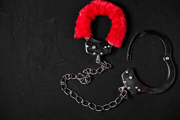 BDSM, bondage play, fetish wear and kinky sex toy concept with close up on erotic mask and red...
