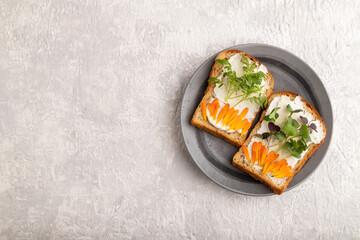 White bread sandwiches with cream cheese, calendula and microgreen on gray. top view, copy space.