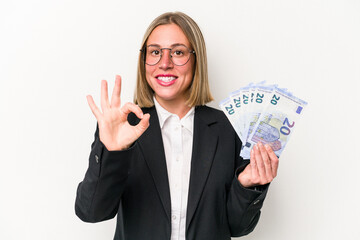 Young business caucasian woman holding banknotes isolated on white background cheerful and...