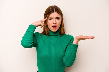 Young caucasian woman isolated on white background holding and showing a product on hand.