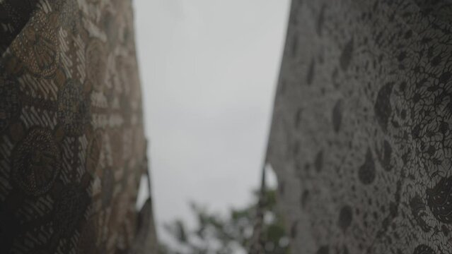 Batik in Java Traditional Fabric of Indonesia - Hanged Cloths Blown by The Wind