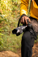 Close-up shot of woman hand holding camera. photographer with mirrorless camera 