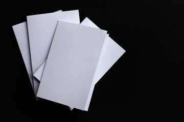 Blank Mock-up paper. brochure magazine isolated on black table, changeable background , white paper...