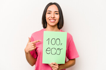 Fototapeta na wymiar Young hispanic woman holding 100% eco placard isolated on white background person pointing by hand to a shirt copy space, proud and confident