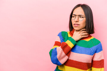 Young hispanic woman isolated on pink background touching back of head, thinking and making a choice.