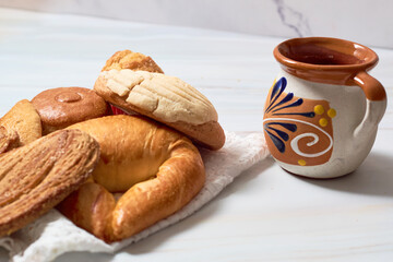 Variety of Mexican sweet bread on marble table