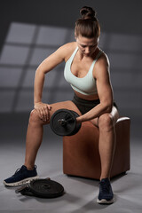 Fototapeta na wymiar Woman doing biceps workout