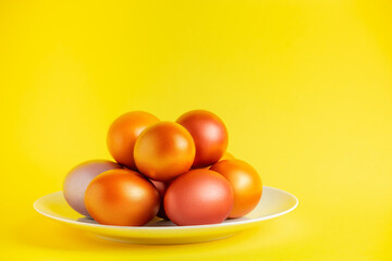 Gold glittering Easter eggs on  yellow background.