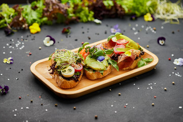 Assorted bruschetta set with salmon, parma and pesto souce. Italian antipasti snacks. Variety mix...