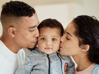 Live with all our love inside of you. Shot of a young family bonding with their baby boy at home.