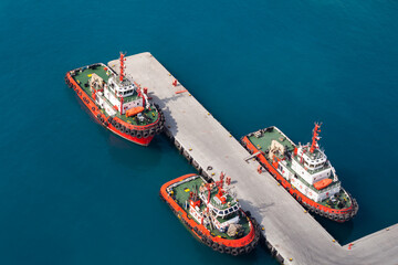 Tug boats are moored in port. Aerial view. Jedda port