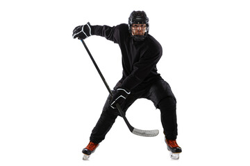 On the run. Male hockey player with the stick on ice court and white background.