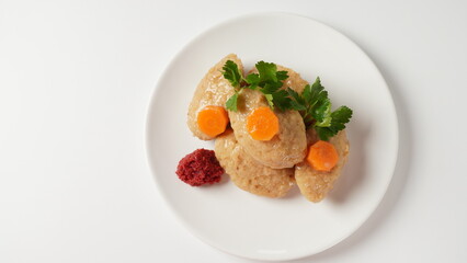 Gefilte fish with carrot. Plate of traditional Passover Pesach gefilte fish on table