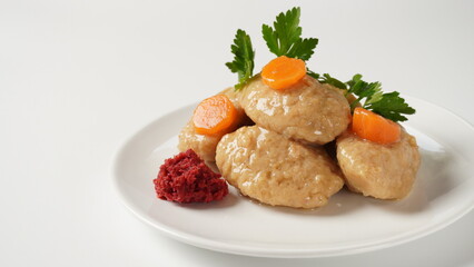 Gefilte fish with carrot. Plate of traditional Passover Pesach gefilte fish on table