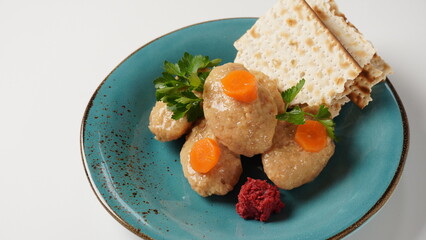 Gefilte fish with carrot. Plate of traditional Passover Pesach gefilte fish on table