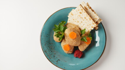 Gefilte fish with carrot. Plate of traditional Passover Pesach gefilte fish on table