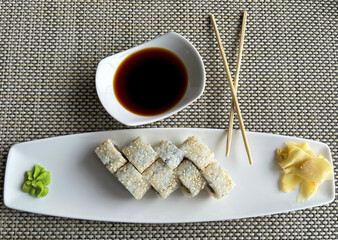 Rolls with salmon and cheese in a plate and soy sauce 