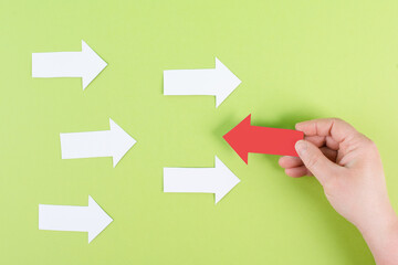White arrows on a green background, one is standing out, do different, be a winner, individuality,...