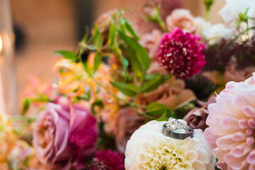 wedding bouquet of flowers and wedding rings 