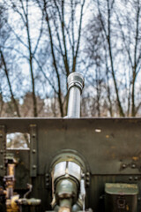 Tank and howitzer stand on the street in Ukraine. In the Kiev park there is a gun and a green tank.